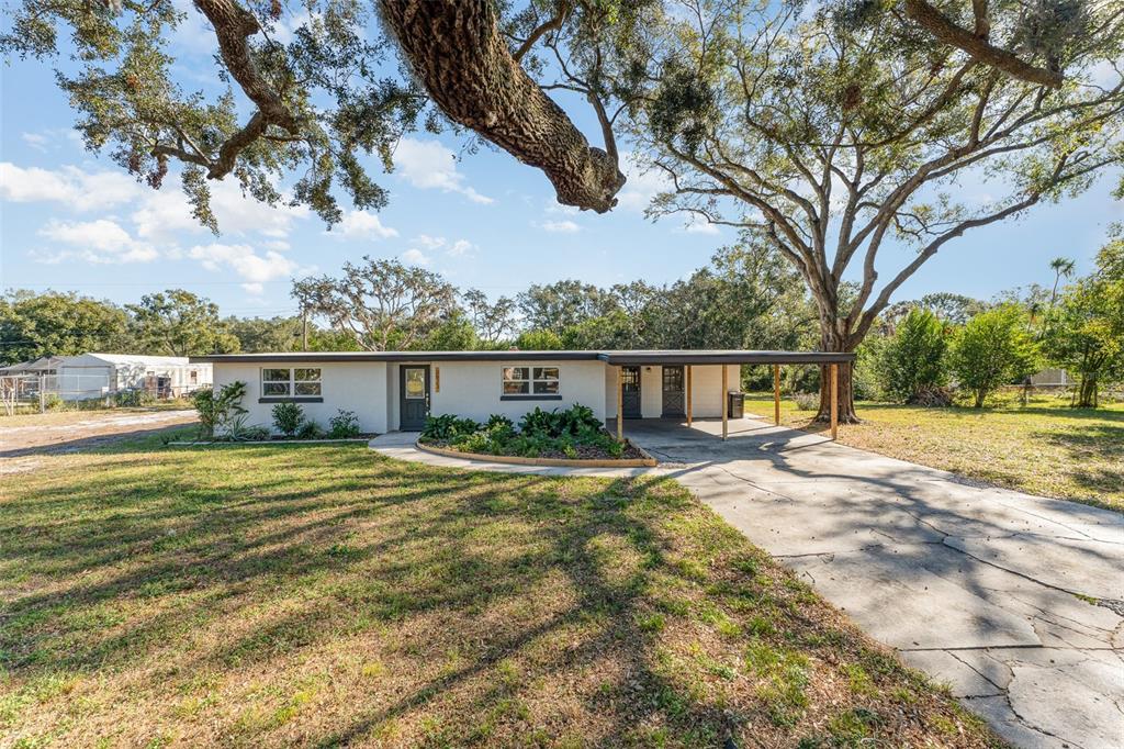 2823 Hurst Road Auburndale, FL 33823 - Photo 1 of 1 a front view of a house with a yard and lake view