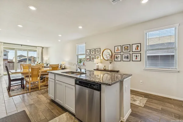 a kitchen with stainless steel appliances granite countertop a sink and cabinets