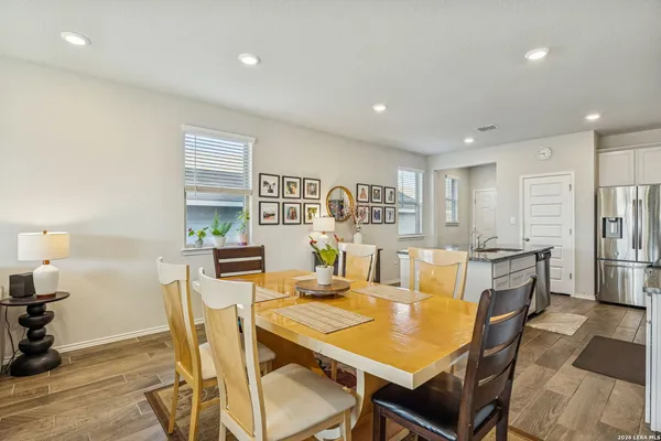 a view of a dining room with furniture and wooden floor