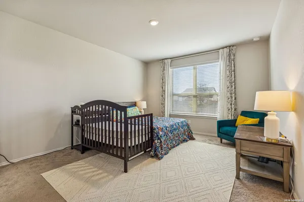 a bedroom with furniture and a window