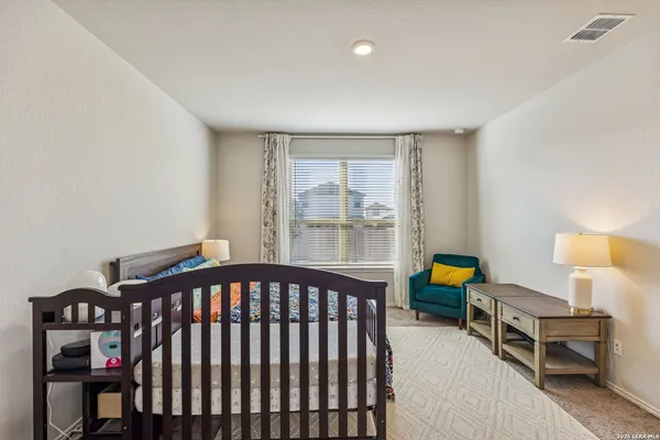 a bedroom with furniture and a window