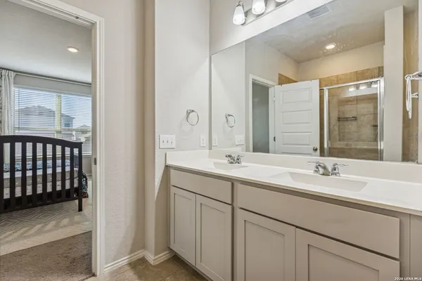 a bathroom with a double vanity sink and mirror