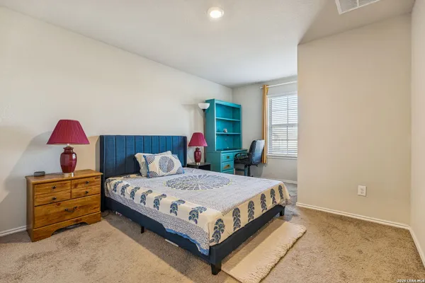 a bedroom with a bed and a dresser