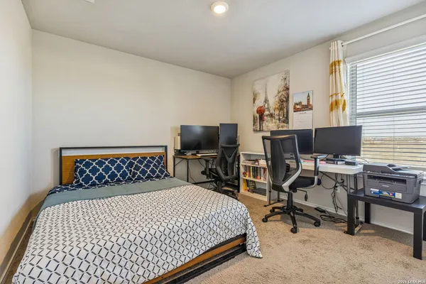 a bedroom with a bed and a desk