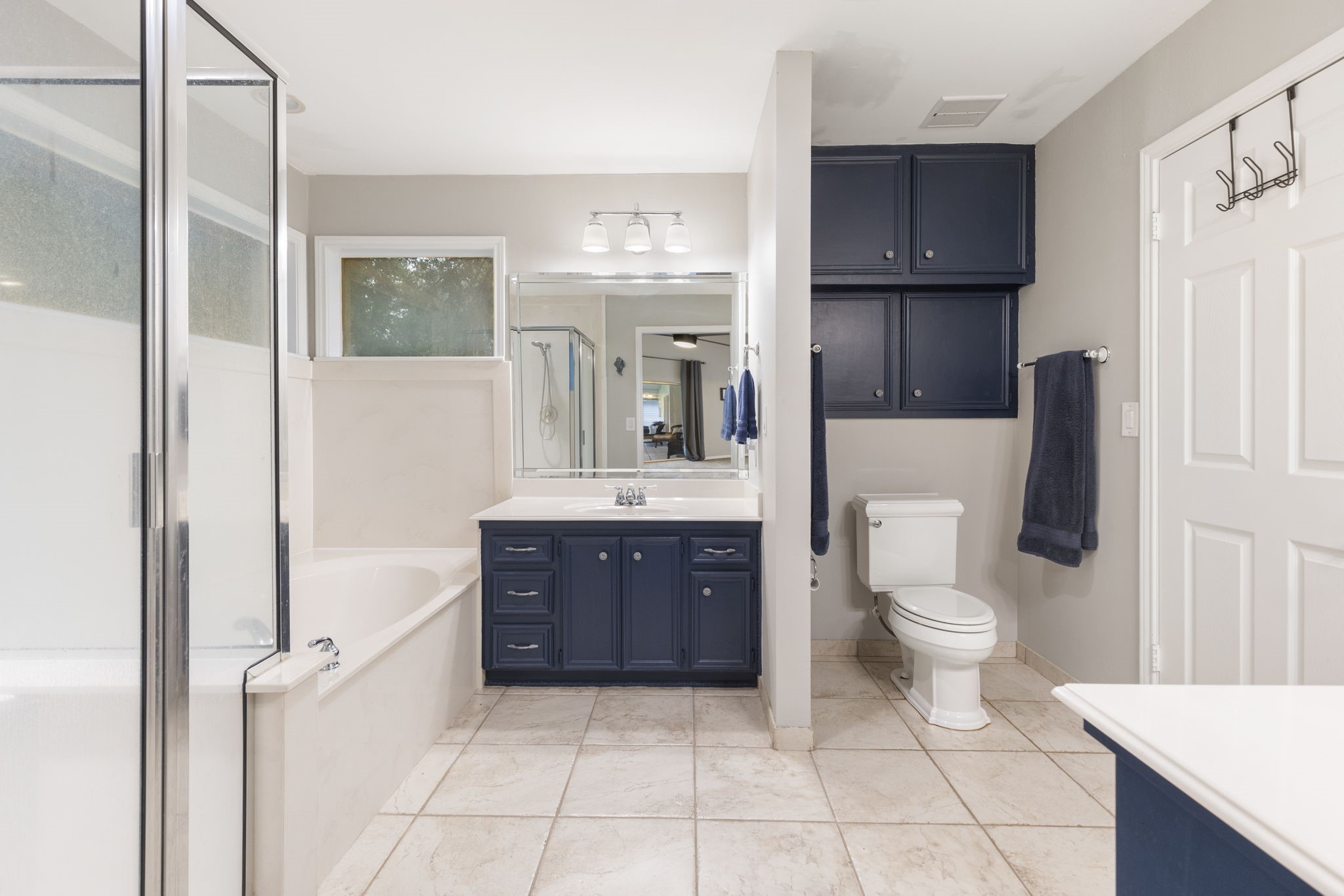 245 Lakeland Road Huntsville, TX 77320 - Photo 22 of 49 The primary bath features dual sinks, soaking tub, and stand-alone shower