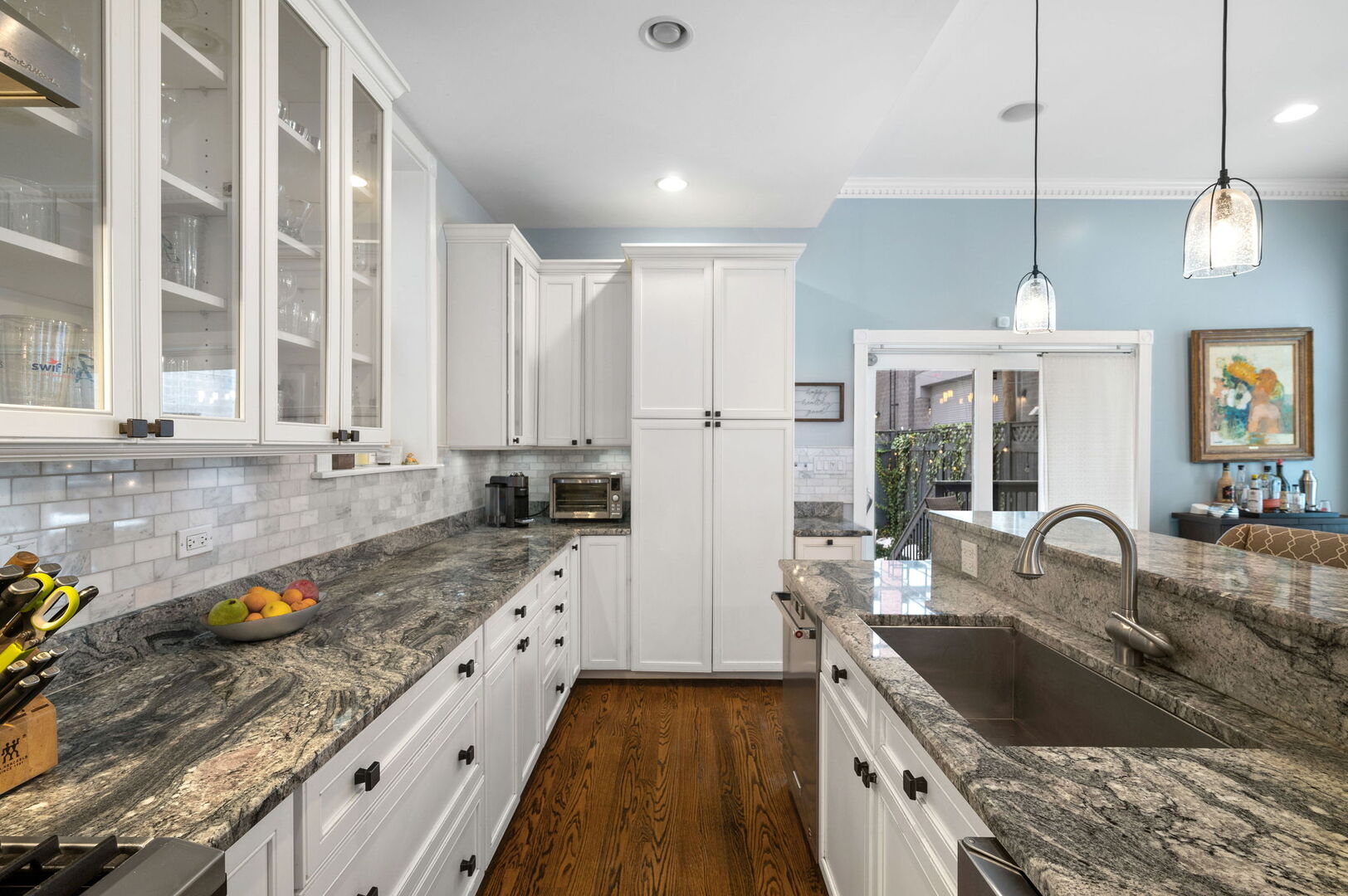 1213 North Paulina Street Chicago, IL 60622 - Photo 11 of 40 a kitchen with granite countertop a sink stove and cabinets