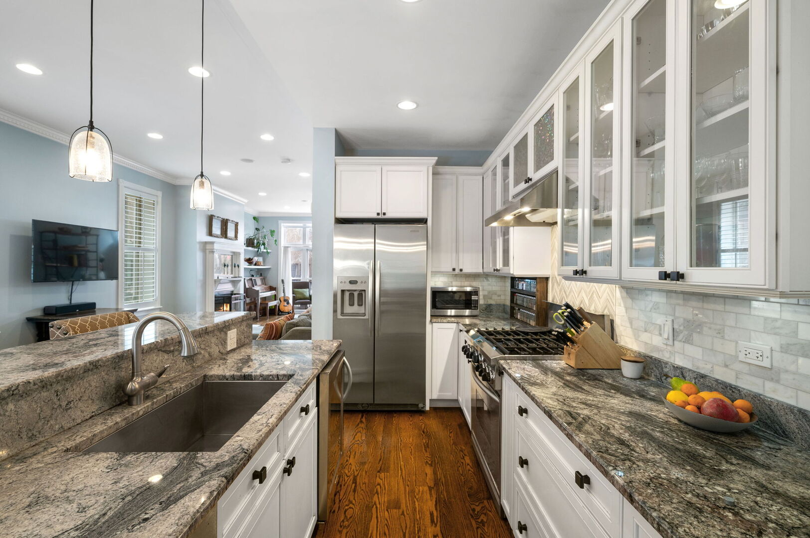 1213 North Paulina Street Chicago, IL 60622 - Photo 12 of 40 a kitchen with stainless steel appliances granite countertop a sink a stove and a refrigerator