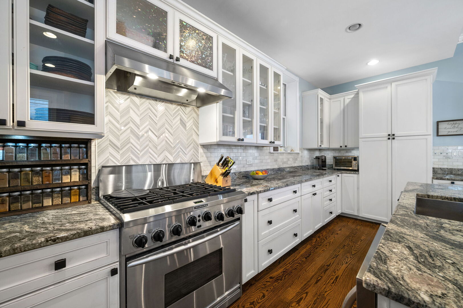 1213 North Paulina Street Chicago, IL 60622 - Photo 13 of 40 a kitchen with granite countertop a stove and cabinets