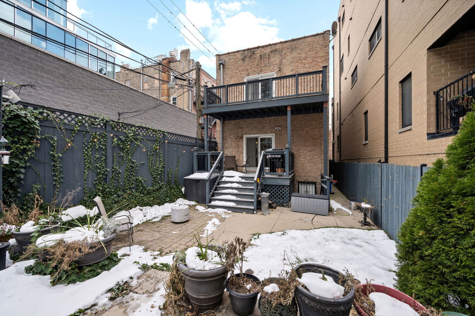 1213 North Paulina Street Chicago, IL 60622 - Photo 36 of 40 a view of a patio with table and chairs and potted plants