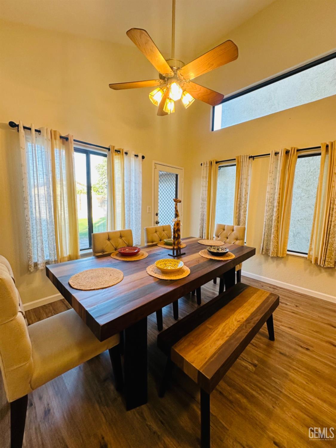 Undisclosed Address Bakersfield, CA 93309 - Photo 11 of 32 a view of a dining room with furniture and wooden floor