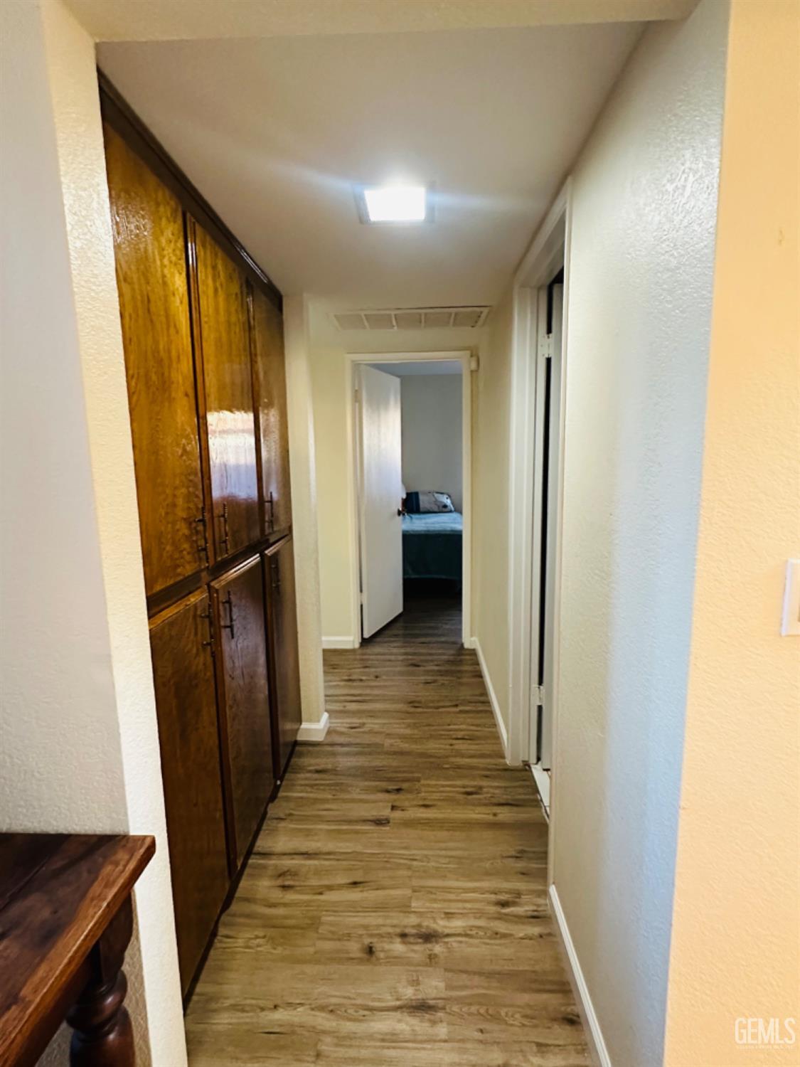 Undisclosed Address Bakersfield, CA 93309 - Photo 12 of 32 a view of a hallway with wooden floor and staircase