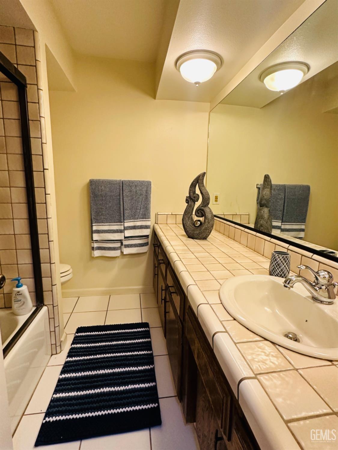 Undisclosed Address Bakersfield, CA 93309 - Photo 13 of 32 a bathroom with a sink and a mirror