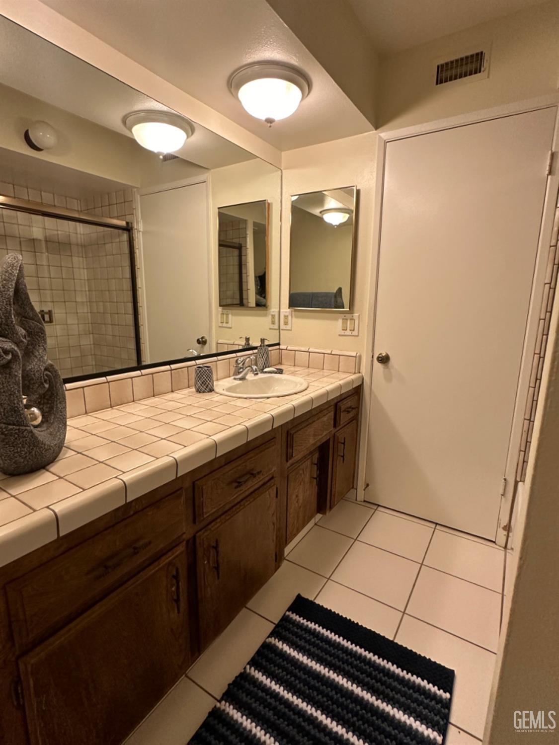 Undisclosed Address Bakersfield, CA 93309 - Photo 14 of 32 a bath room with sink and a mirror