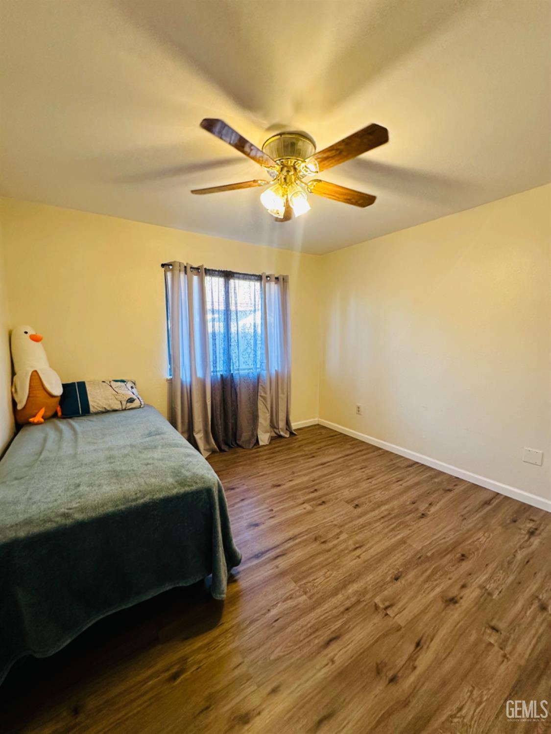Undisclosed Address Bakersfield, CA 93309 - Photo 15 of 32 a bedroom with a bed dresser and a window