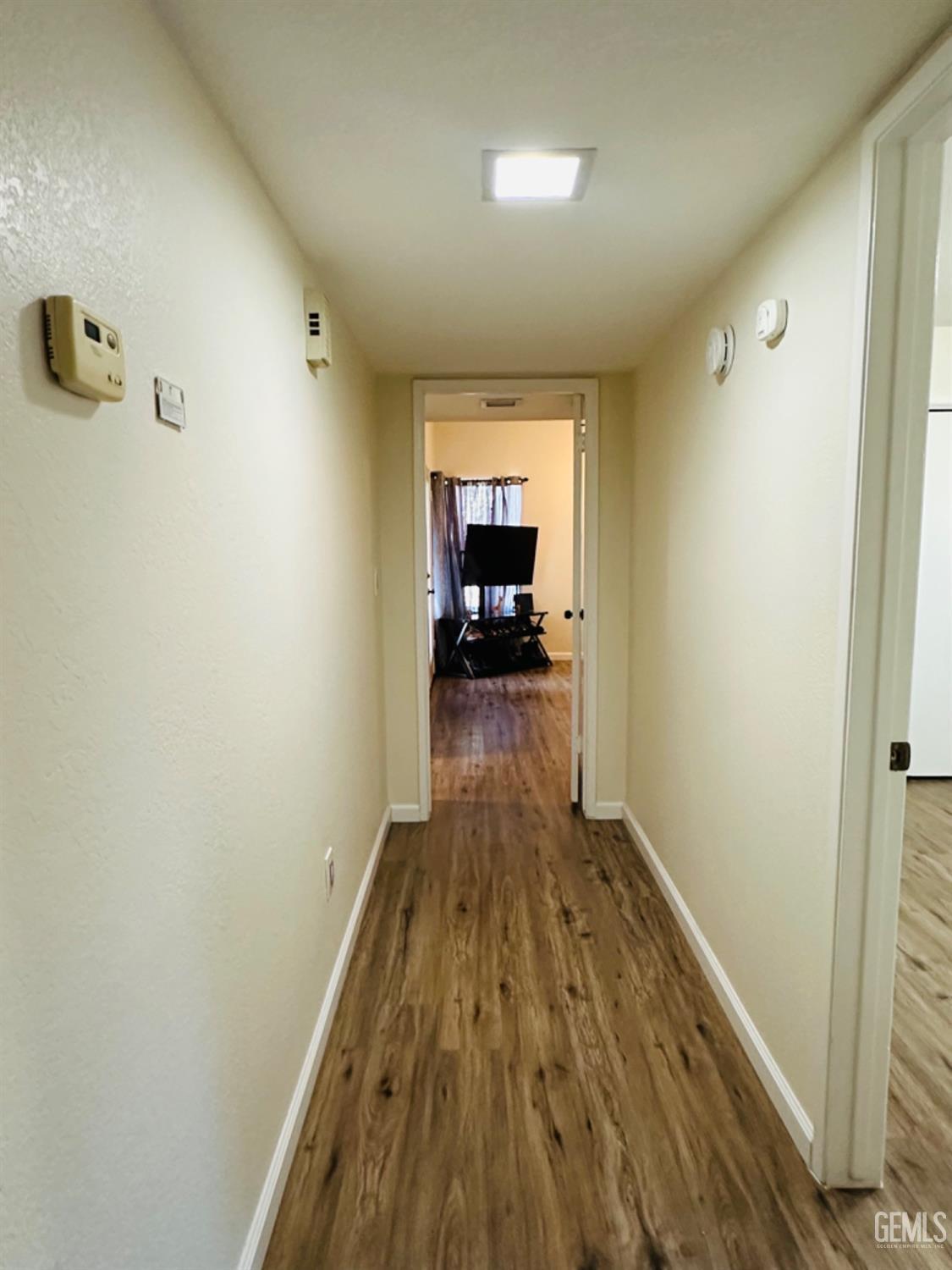 Undisclosed Address Bakersfield, CA 93309 - Photo 19 of 32 a view of a hallway view with wooden floor and furniture