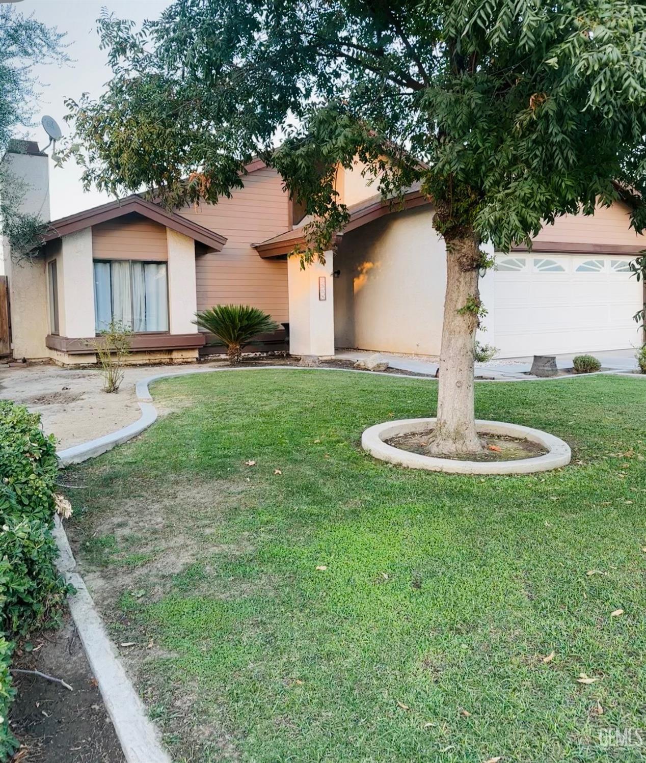 Undisclosed Address Bakersfield, CA 93309 - Photo 2 of 32 a front view of a house with a yard