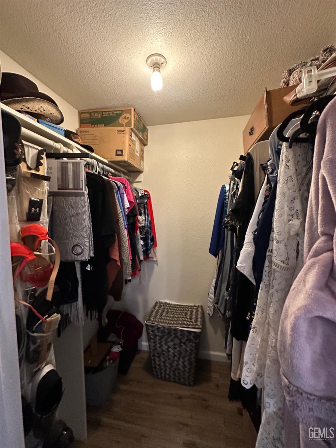 Undisclosed Address Bakersfield, CA 93309 - Photo 22 of 32 a view of walk in closet with clothes and shoes