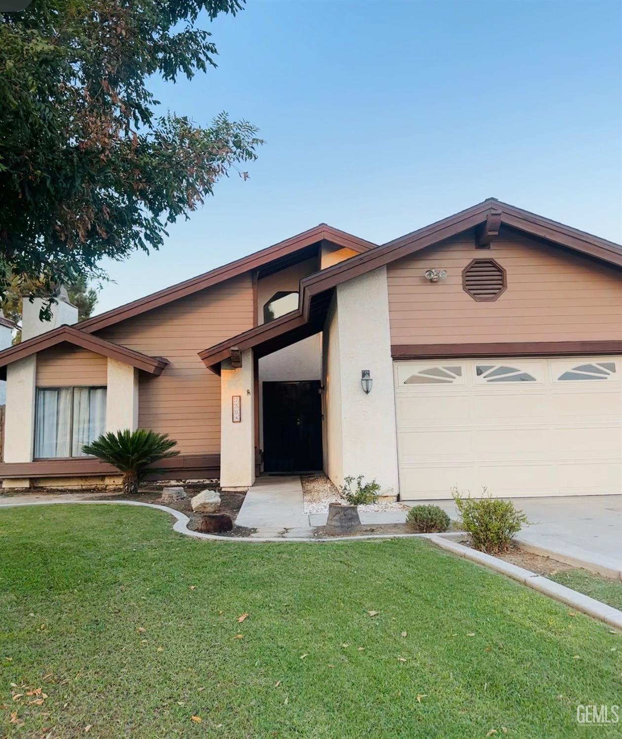 Undisclosed Address Bakersfield, CA 93309 - Photo 3 of 32 a front view of house with yard and green space
