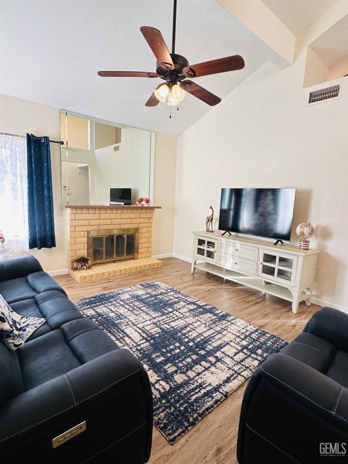 Undisclosed Address Bakersfield, CA 93309 - Photo 5 of 32 a living room with furniture and a flat screen tv