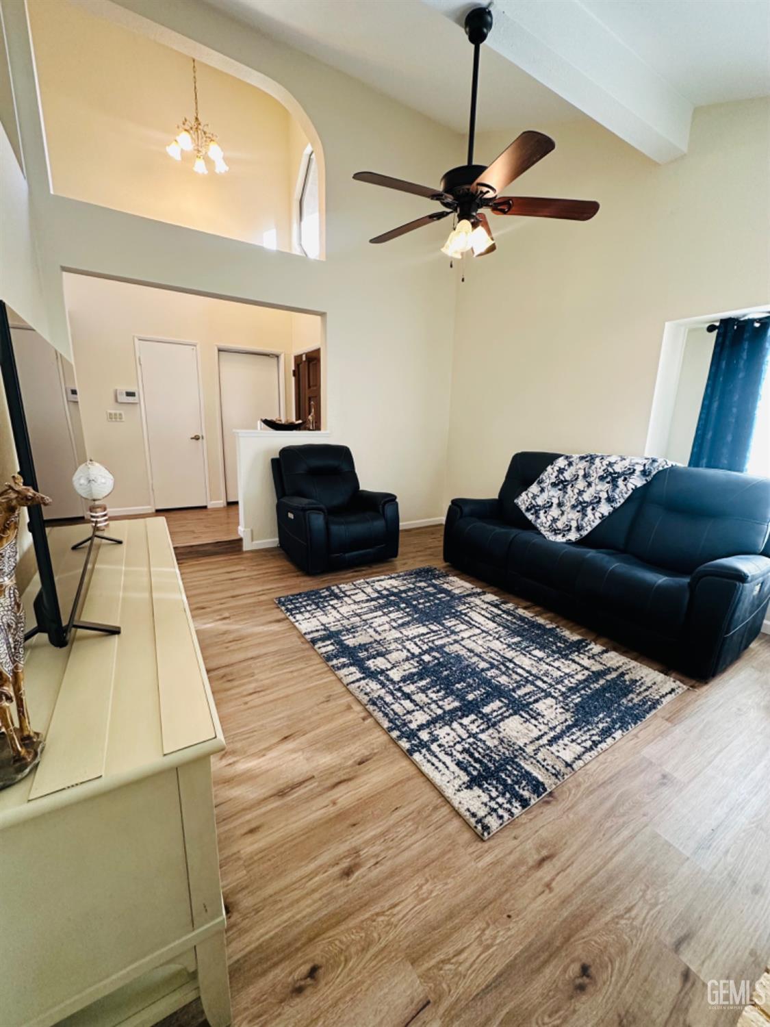 Undisclosed Address Bakersfield, CA 93309 - Photo 6 of 32 a living room with a couch and a ceiling fan