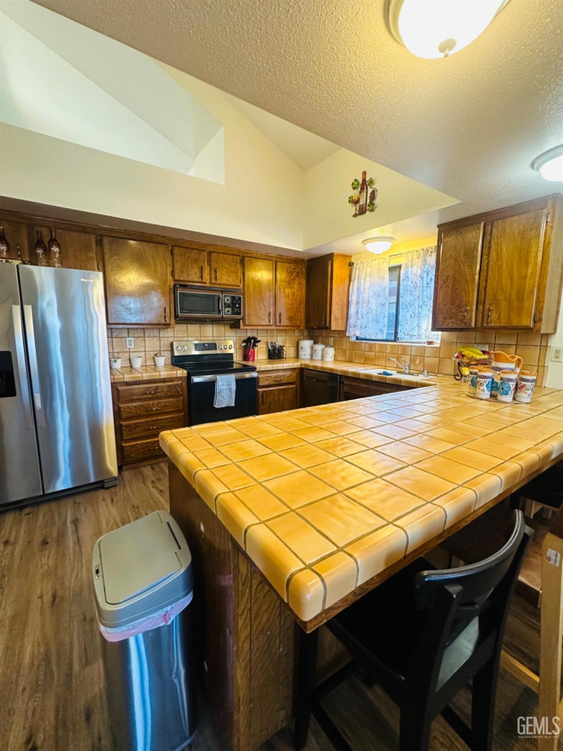 Undisclosed Address Bakersfield, CA 93309 - Photo 9 of 32 a large kitchen with a table and chairs in it