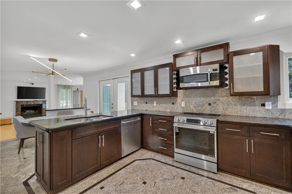 4610 West Morton Road Alpharetta, GA 30022 - Photo 15 of 53 a kitchen with stainless steel appliances granite countertop a sink stove and oven