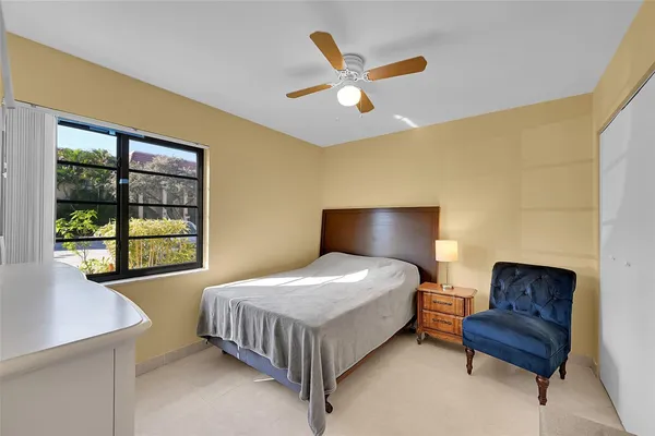 a bedroom with a bed couch and window