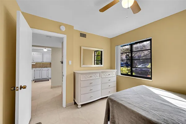 a view of a bedroom with a cabinet and a flat screen tv
