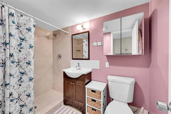 a bathroom with a toilet sink and mirror