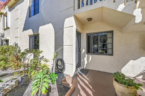a front view of a house with outdoor seating and flowers
