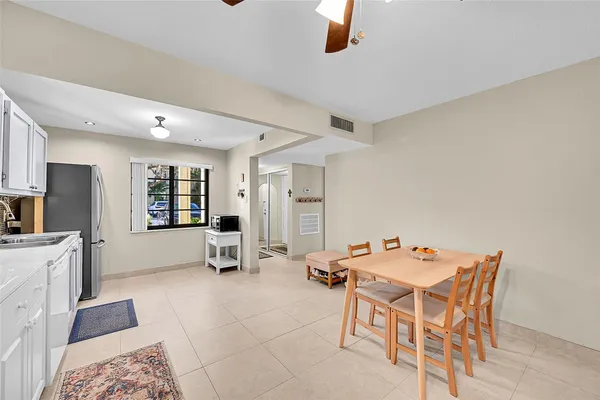 a room with furniture a flat screen tv and white walls