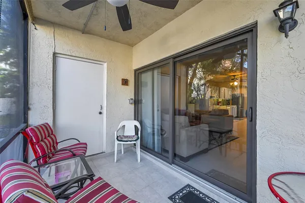 a living room with furniture and a floor to ceiling window