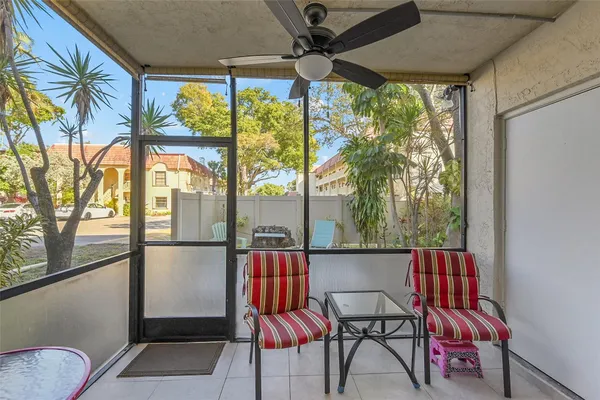 a view of a porch with furniture and a yard