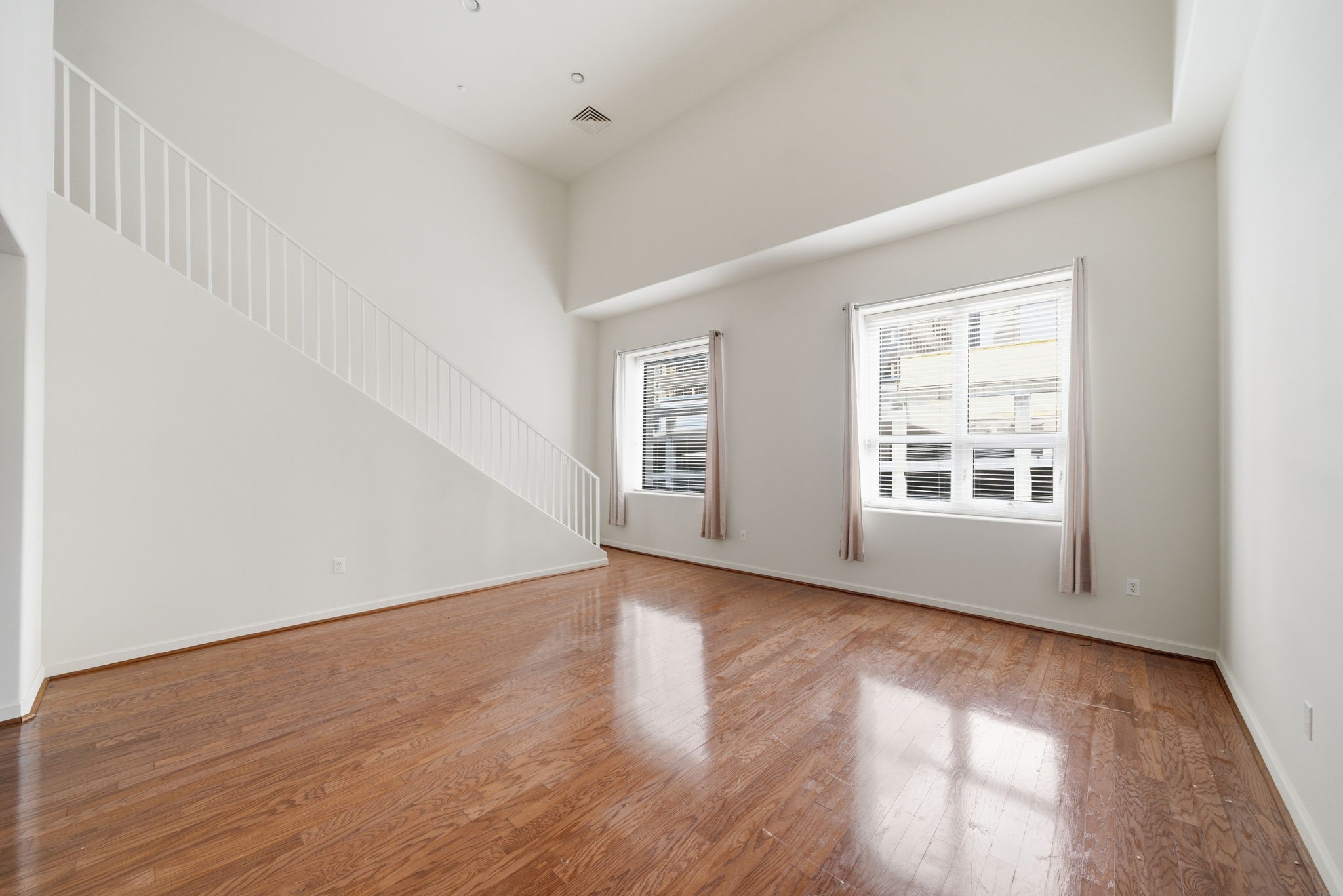 914 Main Street, Unit 1108 Houston, TX 77002 - Photo 2 of 24 a view of an empty room with wooden floor and a window