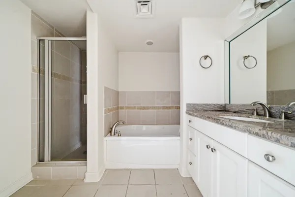 a bathroom with a tub sink and mirror