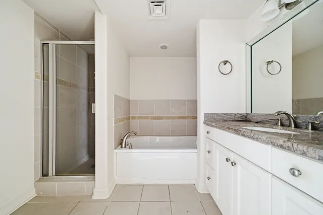 a bathroom with a tub sink and mirror