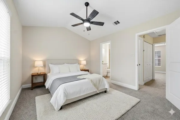 a bedroom with bed and window