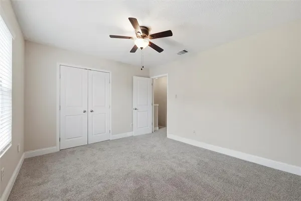 a view of a livingroom with a ceiling fan and window