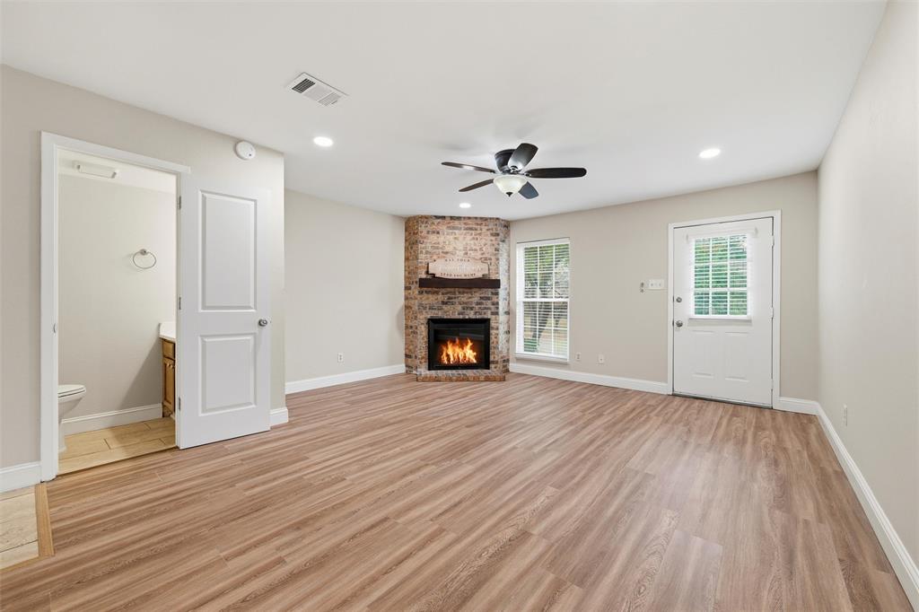 112 Churchill Lane Euless, TX 76039 - Photo 3 of 33 a view of an empty room with wooden floor and a fireplace