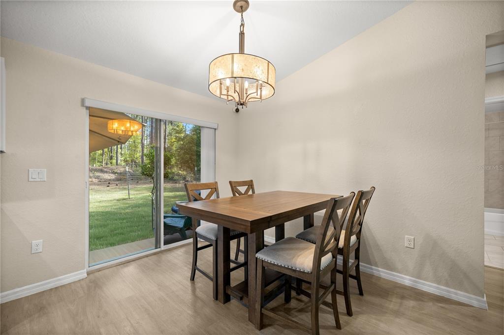 13131 Southwest 73rd Street Ocala, FL 34481 - Photo 11 of 30 a view of a dining room with furniture window and outside view