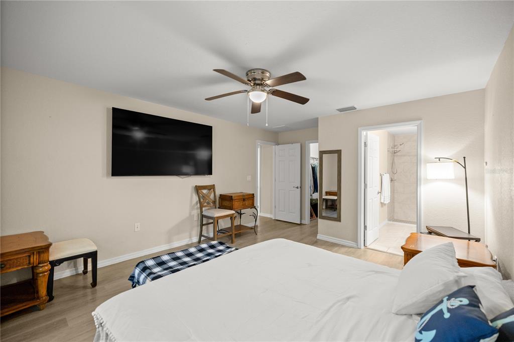 13131 Southwest 73rd Street Ocala, FL 34481 - Photo 12 of 30 a bedroom with a bed and a flat screen tv