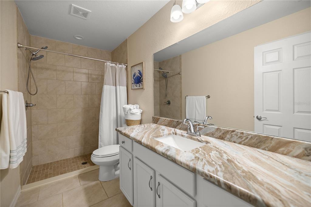 13131 Southwest 73rd Street Ocala, FL 34481 - Photo 14 of 30 a bathroom with a granite countertop sink toilet and shower
