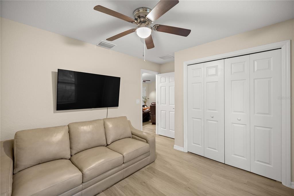 13131 Southwest 73rd Street Ocala, FL 34481 - Photo 17 of 30 a living room with furniture and a flat screen tv