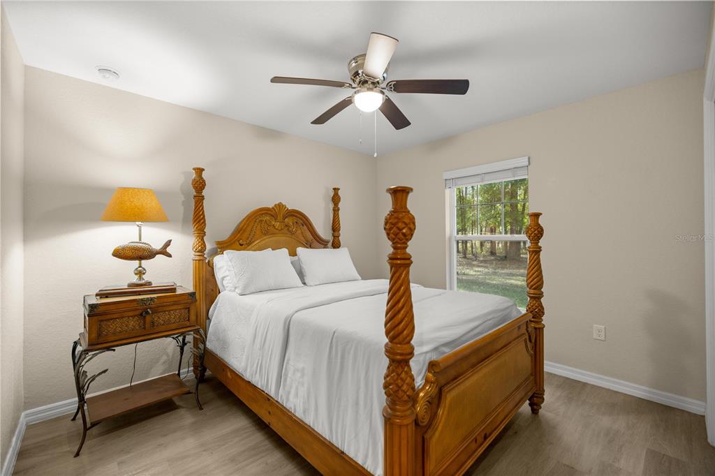 13131 Southwest 73rd Street Ocala, FL 34481 - Photo 18 of 30 a bed room with a bed and a lamp
