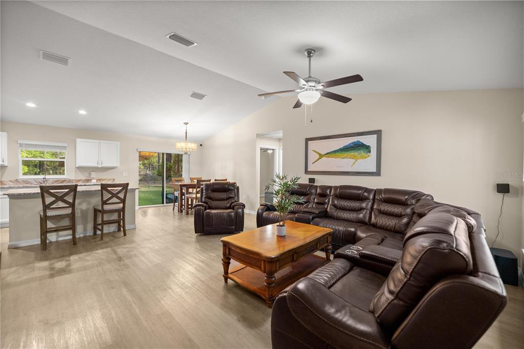 13131 Southwest 73rd Street Ocala, FL 34481 - Photo 5 of 30 a living room with furniture kitchen view and a chandelier