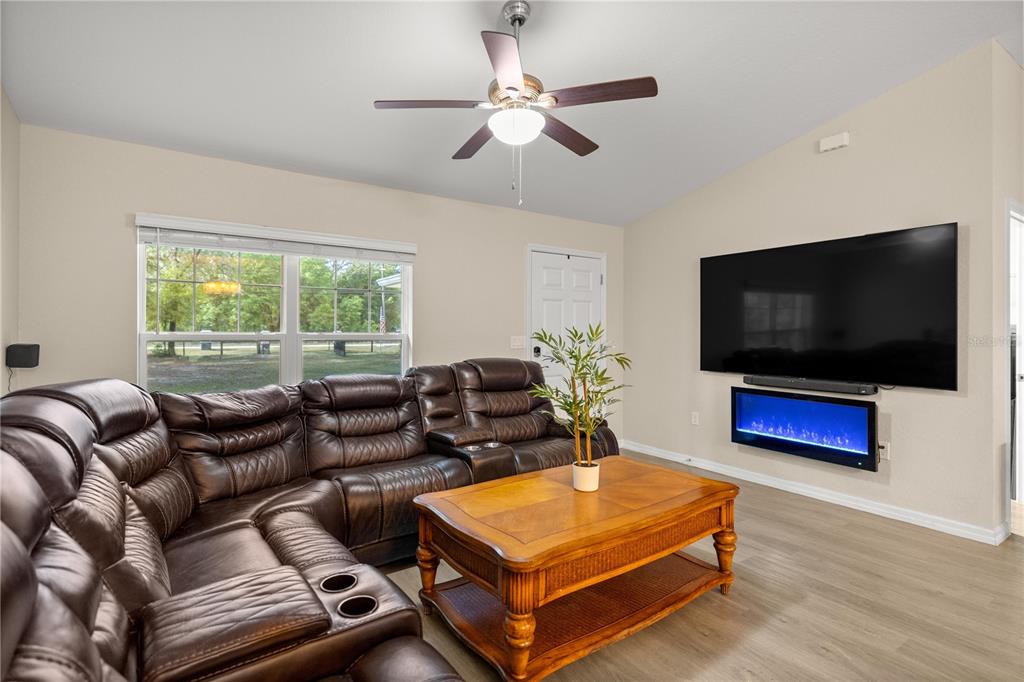 13131 Southwest 73rd Street Ocala, FL 34481 - Photo 6 of 30 a living room with furniture and a flat screen tv