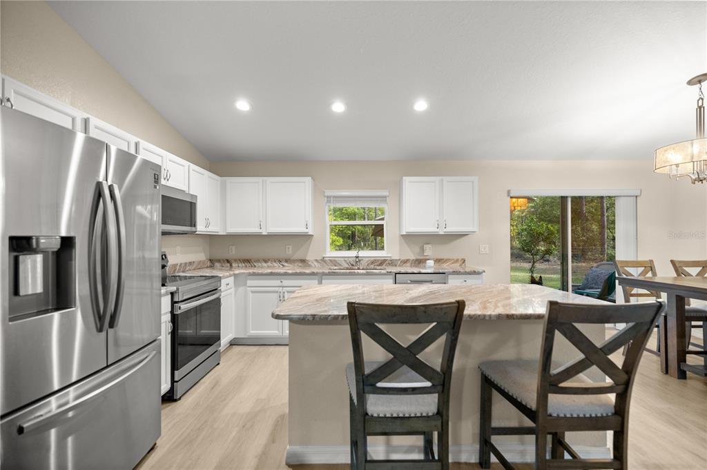 13131 Southwest 73rd Street Ocala, FL 34481 - Photo 9 of 30 a kitchen with appliances cabinets and chair
