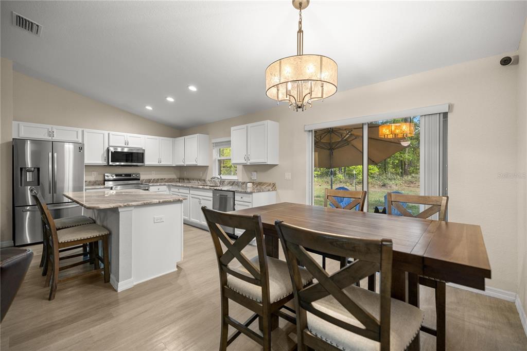 13131 Southwest 73rd Street Ocala, FL 34481 - Photo 10 of 30 a view of a dining room with furniture window and wooden floor