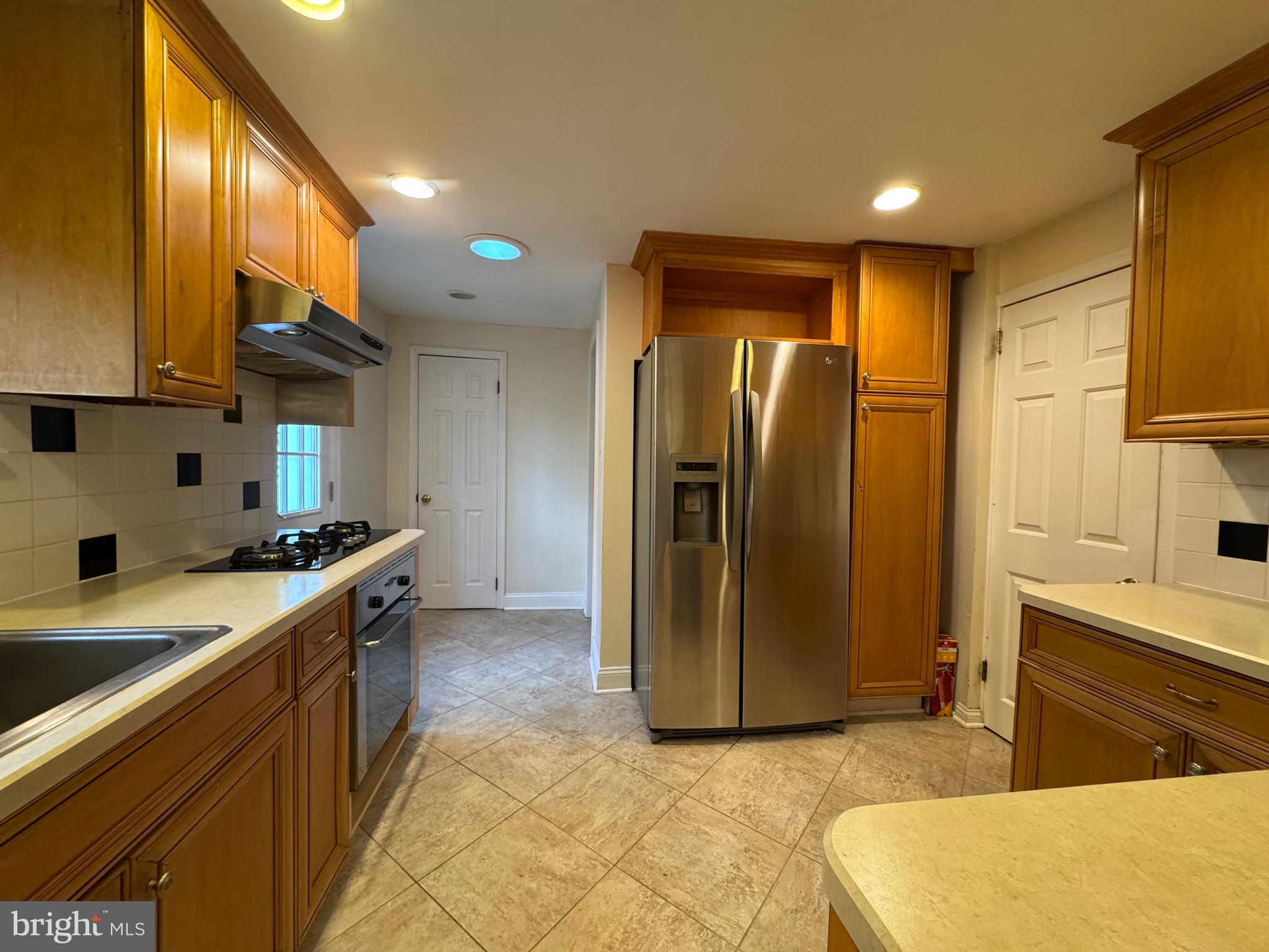 412 Grange Road Wayne, PA 19087 - Photo 15 of 27 a kitchen with stainless steel appliances granite countertop a refrigerator a stove and a sink