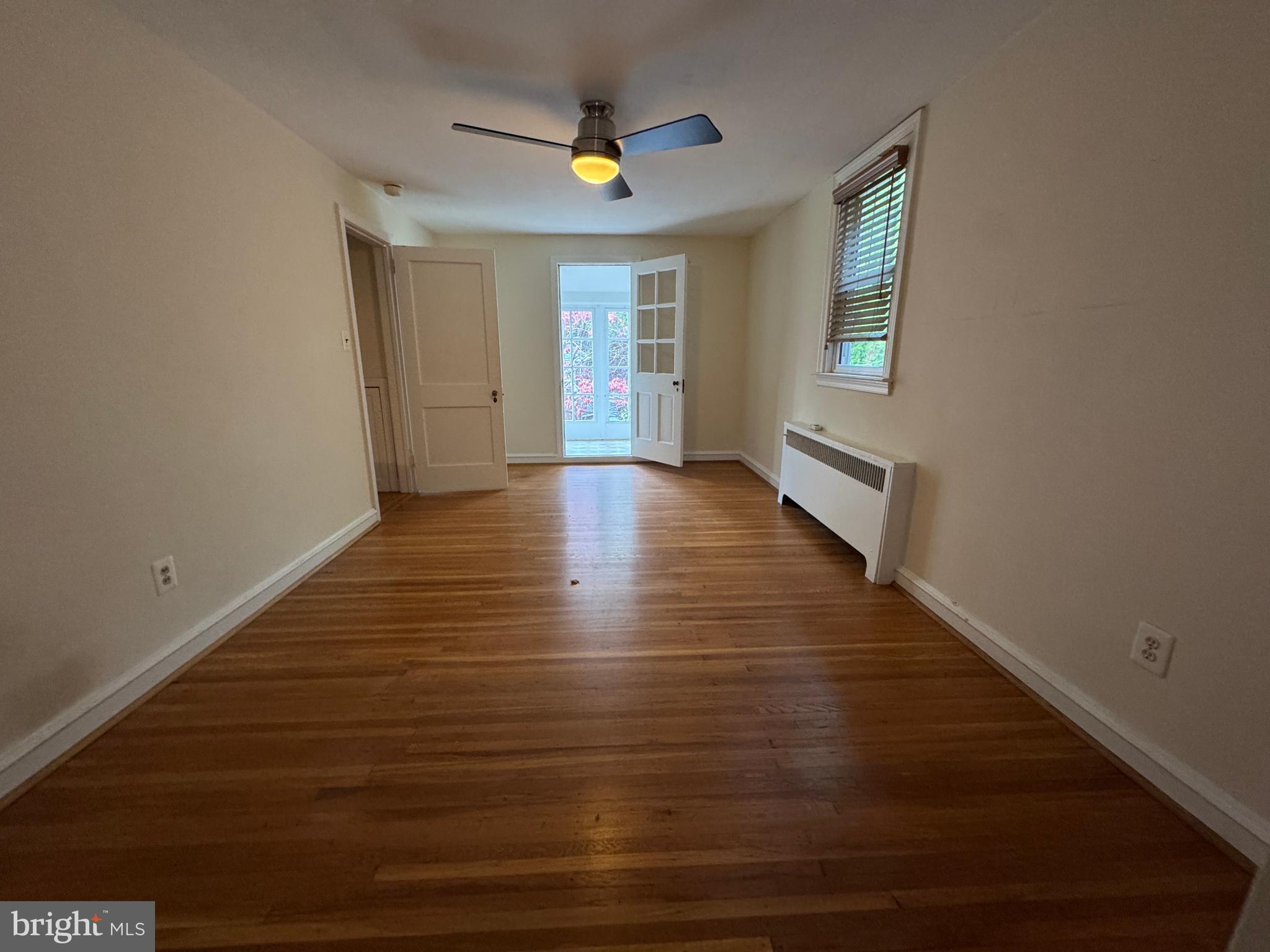 412 Grange Road Wayne, PA 19087 - Photo 21 of 27 a view of an empty room with wooden floor and a window